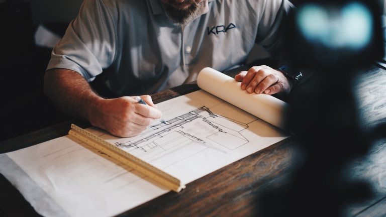 man working on construction plans