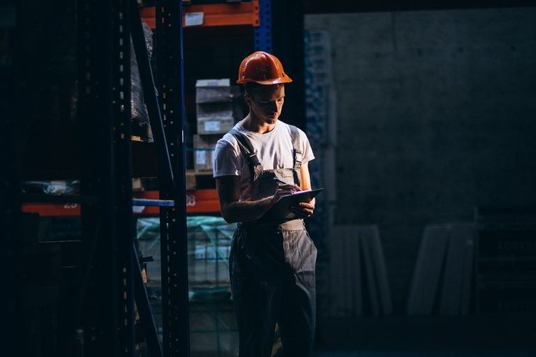 worker inspecting steel plates