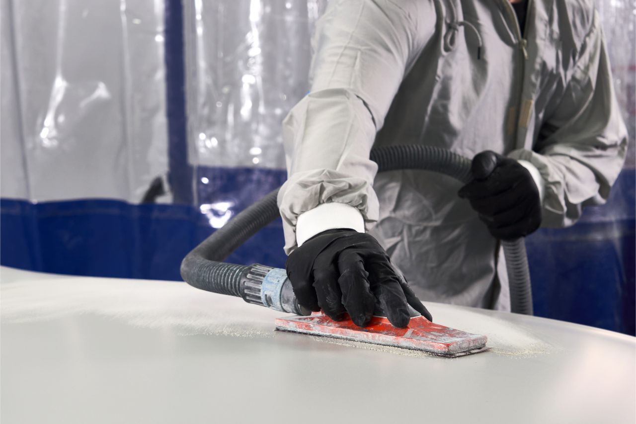 A man buffing metal for a project