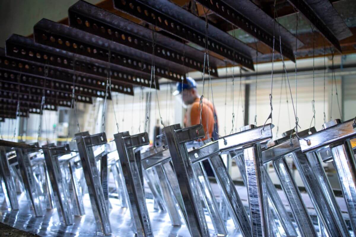 Steel supplier conducting strict quality control inspections in a warehouse facility