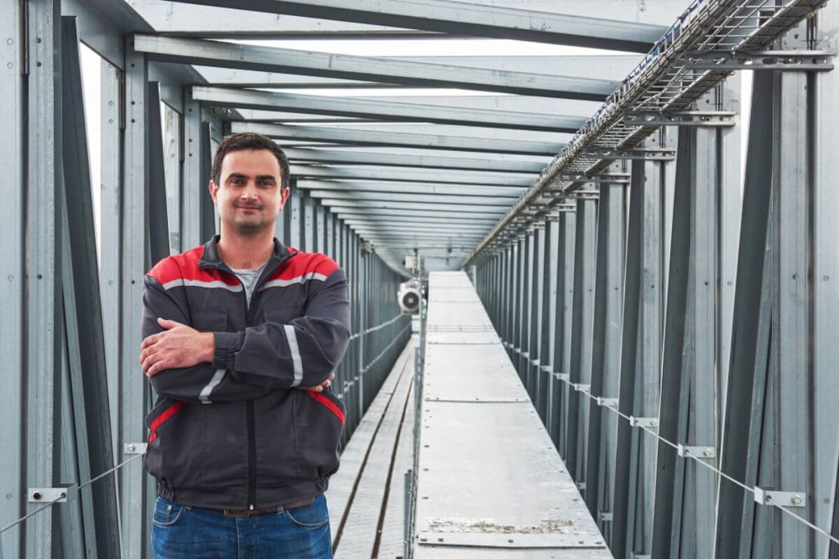 Engineer standing inside a wide flange steel structure used for stable industrial and infrastructure construction
