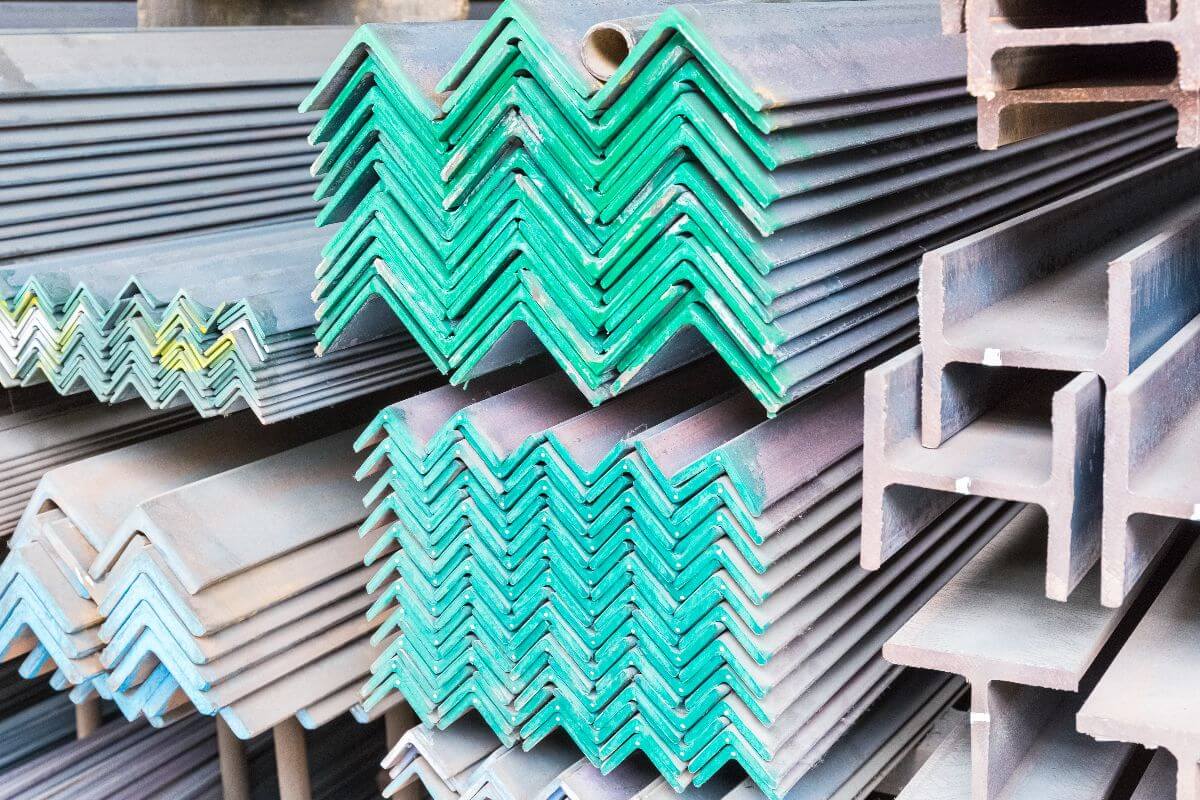 Stacked angle bars and steel sections stored in a supplier’s yard